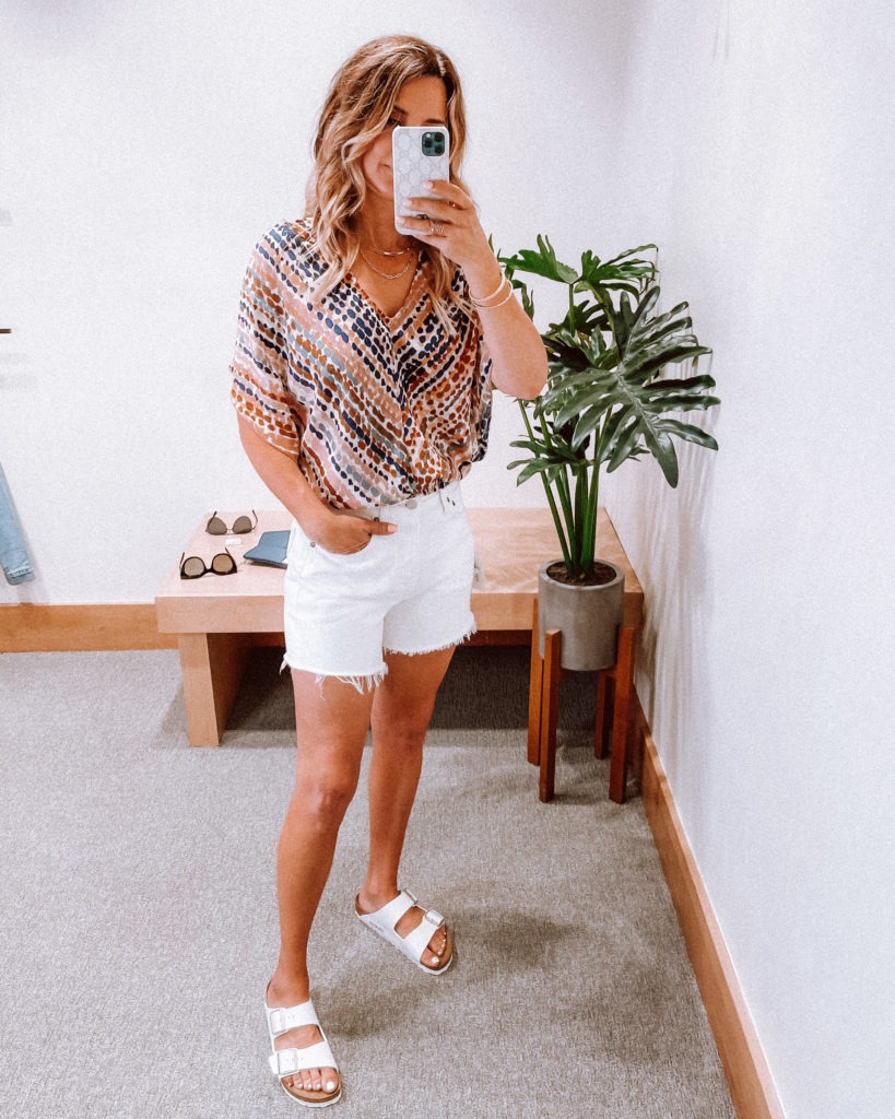 Her Fashioned Life wearing white denim shorts and white sandals from Evereve