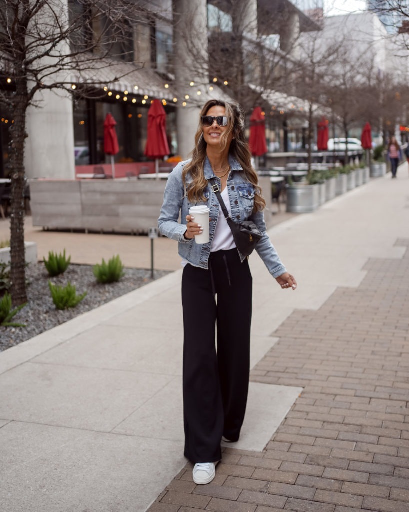 Her Fashioned Life wearing black wide-leg pants and a denim jacket for spring
